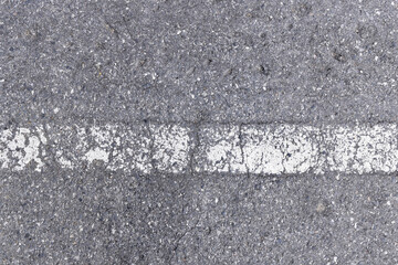 horizontal grunge white paint dividing line on tarmac highway