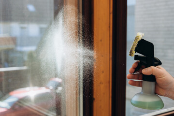 Cleaning window with spray bottle and sponge for a sparkling shine and clear view home cleaning concept