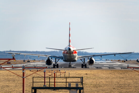 An American Airlines aircraft lines up on the runway at Ronald Reagan Washington National Airport (DCA), preparing for takeoff on a crisp winter morning.