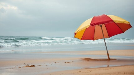 Abandoned beach umbrella depicting sadness on a stormy day  
