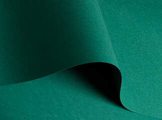 Green paper texture with vibrant emerald and jewel green tones, matte surface with curved folded...