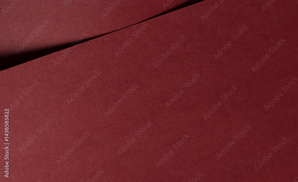 Aufkleber matt paper texture with deep red and maroon tones, sleek folded design and bold contrast along curve