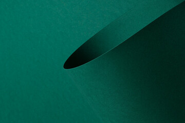 Matte paper texture with vibrant emerald and jewel green tones, sleek rolled design with curved...