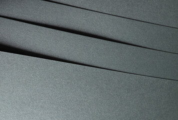 Paper texture with glossy finish, chic layered designer paper in dark green, forest green, and...