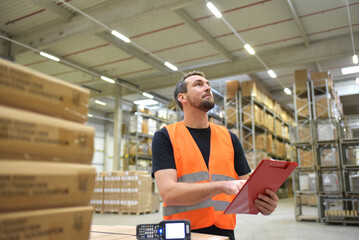 friendly warehouse worker in a warehouse with the barcode scanner