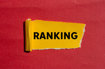 Ranking message written on ripped torn yellow paper on red background. Conceptual ranking symbol....