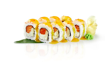 Sushi rolls covered with mango sauce resting on a bamboo leaf
