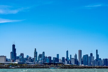 Fototapeta premium The Skyline of Downtown Chicago and Lake Michigan as viewed from Margaret T. Burroughs Beach along DuSable Lakeshore Drive