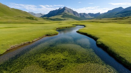 Obraz premium Explore lush meadows and a crystal-clear river meandering through the enchanting valley with majestic mountains in the distance