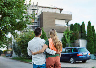 key woman man house new apartment home wife husband owner real estate togetherness couple buying happy young married together family property portrait