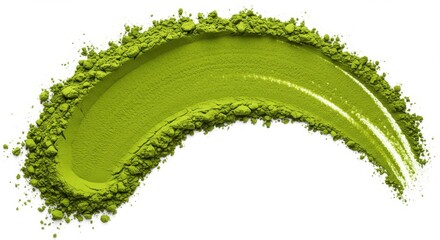 A curved smear of vibrant green matcha powder against a stark white background in a studio shot