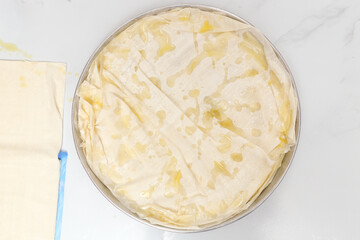 filo pastry in tray with olive oil drops