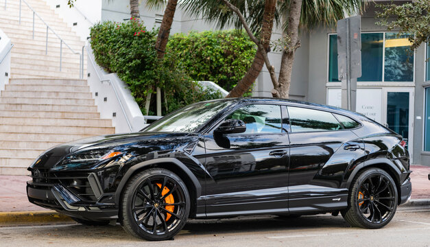 Miami, Florida, USA - December 08, 2024: 2023 Lamborghini Urus S SUV sportscar. Luxury sport car of Lamborghini Urus S type. Car of Lamborghini Urus parked outdoor. black Lamborghini Urus, side view.
