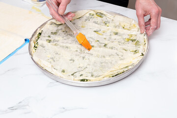 woman in kitchen preparing spinach pie
