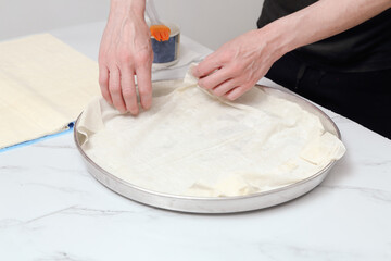 woman in kitchen preparing spinach pie