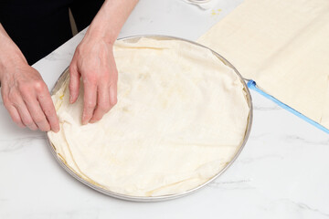 woman in kitchen preparing spinach pie