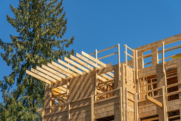 Modern apartment building under construction. The site with wooden frame in Vancouver, Canada, North America. Day time on April 2025.