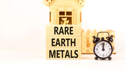 Rare earth metals symbol. Concept words Rare earth metals on beautiful wooden block. Black alarm...