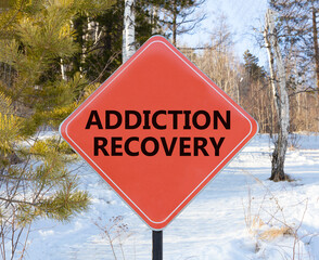 Addiction recovery symbol. Concept words Addiction recovery on beautiful red road sign. Beautiful...