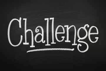Obraz premium Chalkboard texture with the word Challenge written in white chalk, suggesting overcoming obstacles and achieving goals