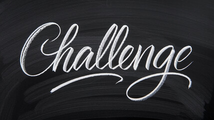 White chalk lettering spelling "Challenge" on a black chalkboard background, showcasing a handwritten, elegant script style, symbolizing ambition and overcoming obstacles