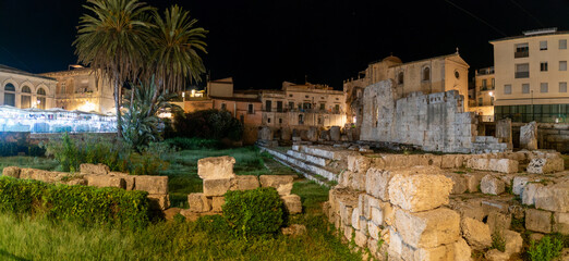 Panoramic view of the old town of Syracuse in Sicily, Italy in a beautiful warm night. Travel and sightseeing journey concept.