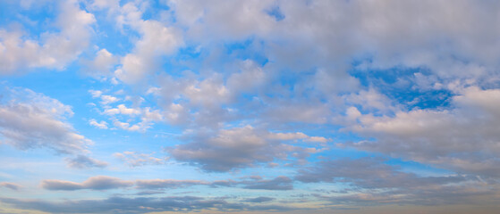 Obraz premium heaven sky is blue with many clouds. The clouds are white and fluffy. The sky is clear and bright.