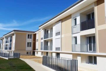 Modern apartment buildings, beige facades, and balconies