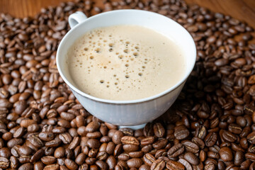 coffee beans in a vintage white cup