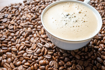 coffee beans in a vintage white cup