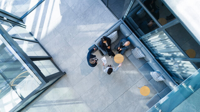 Business people, top view and meeting in building with collaboration, financial pitch with document for strategy. Above, tax accountant and table teamwork with budget paper for economy in office