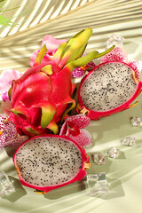 Dragon fruit, pitaya on a sunny table with shadows from a palm tree and orchid flowers, advertising card for a store. Summer banner with tropical exotic fruits. Healthy vegan food for weight loss