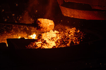Removing slag from surface of hot iron in melting furnace