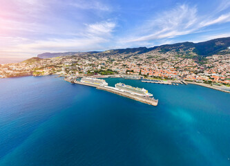 Fototapeta premium Majestic cruise ship sailing across tranquil waters near vibrant coastal town