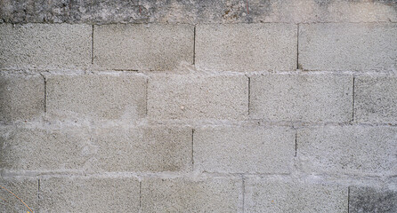 Obraz premium Muro de bloques de cemento gris con textura rugosa - foto de stock