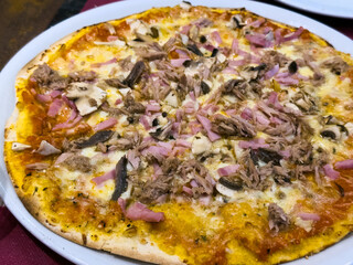 Close-up of handmade Italian pizza on dark background