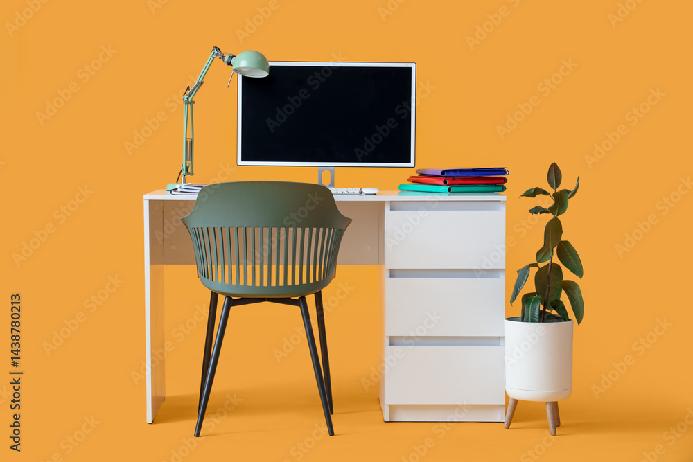 Poster comfortable table with modern computer, lamp and folders on yellow background