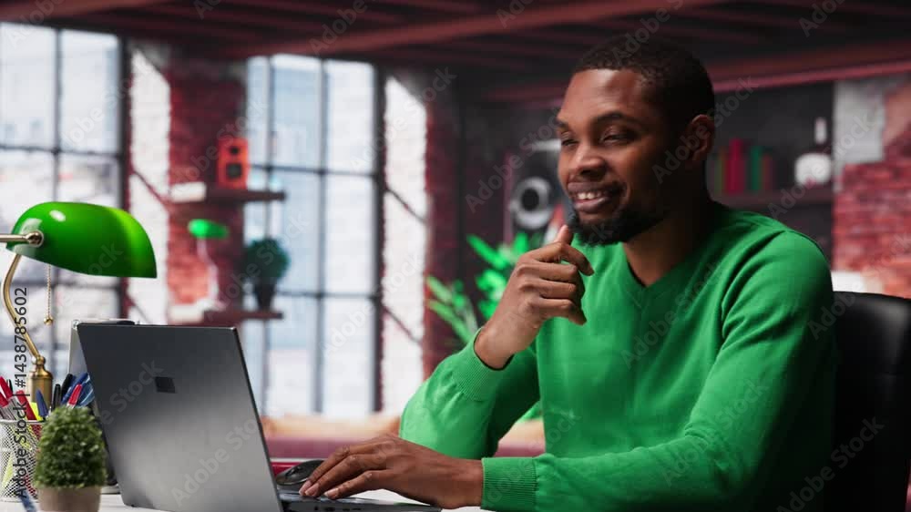 Poster black remote employee in home office using laptop for web assignments, preparing presentation slides