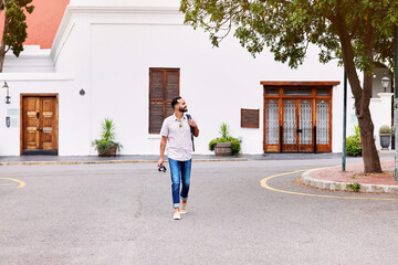 Walking, travel and man on vacation in city for sightseeing with backpack and camera for journey....