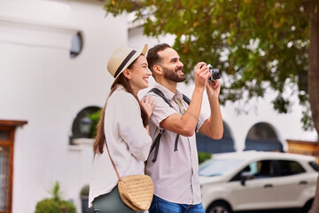 Happy, couple and tourist with photography outdoor for adventure, sightseeing and together for...