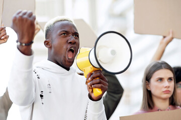 Closeup of black motivated guy with loudspeaker leading international group of strikers,...
