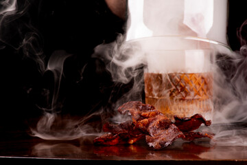 opening smoker with smoked old fashioned cocktail crispy bacon slices in focus