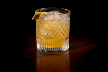 refreshing cocktail glass of sicilian lemon whiskey and ice gin and mint in pub with black