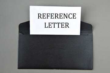REFERENCE LETTER - words on white paper on a black envelope with a magnifying glass