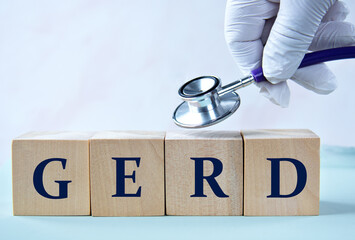 Cubes with the abbreviation GERD in the hand of a doctor.