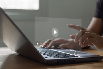 Concept about subscription based live digital stream. Video streaming on internet. Man hands using laptop computer for streaming and watching online movie, TV series, live concert, show or tutorial.