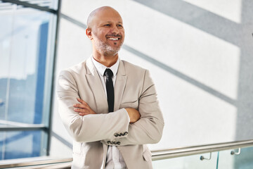 Mature man, arms crossed and thoughtful in office, ideas and professional for insight or...
