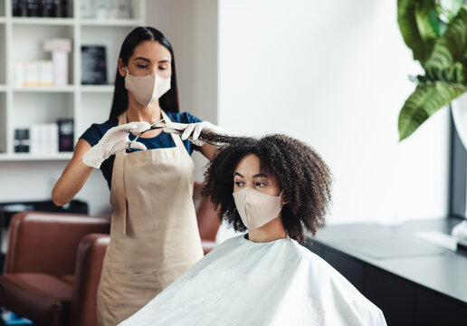 Haircare during pandemic. African american girl cutting split ends at beauty salon, free space