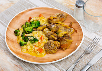Appetizing fried chicken pieces served on plate with broccoli