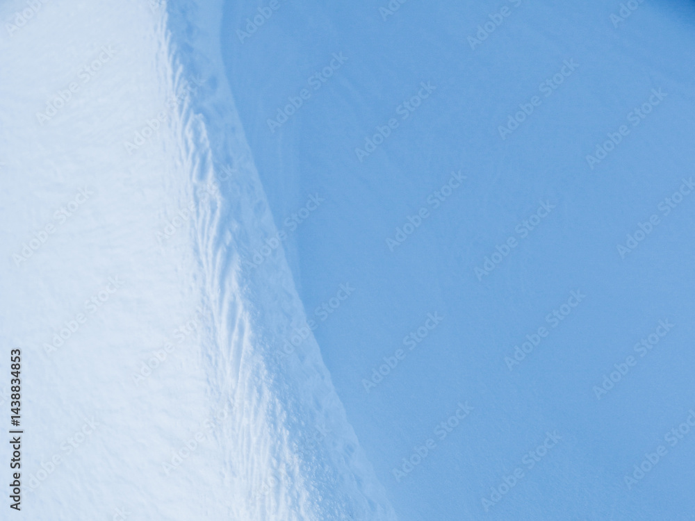 Wall mural snow texture. wind sculpted patterns on snow surface. wind in the tundra and in the mountains on the